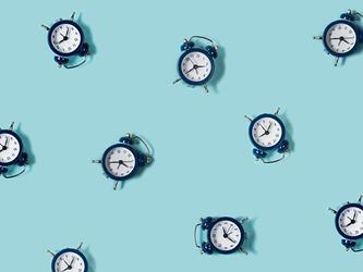 lots of round clocks against a blue background